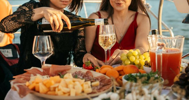 people celebrating on the boat while enjoying party food